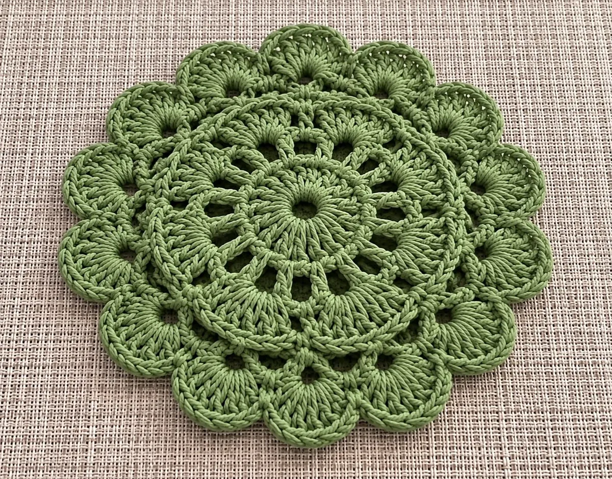 Sage flower doily Sage flower doily, handmade crochet by Atelier Annamaria. Green petal doily with a lacy centre.