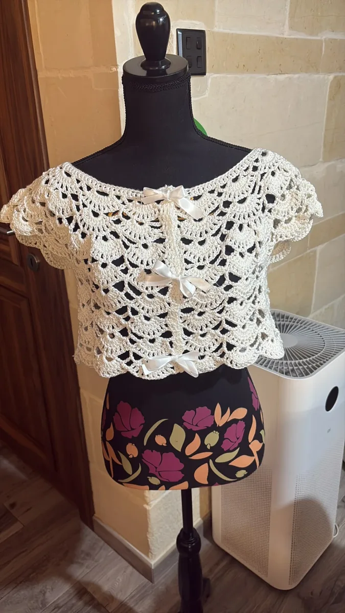 Ivory shell bow top, handmade crochet by Atelier Annamaria. Lacy ivory shell-stitch top with cap sleeves and satin bows.